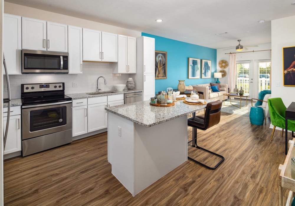 Apartment kitchen with spacious granite island at The Iris at Northpointe in Lutz, Florida