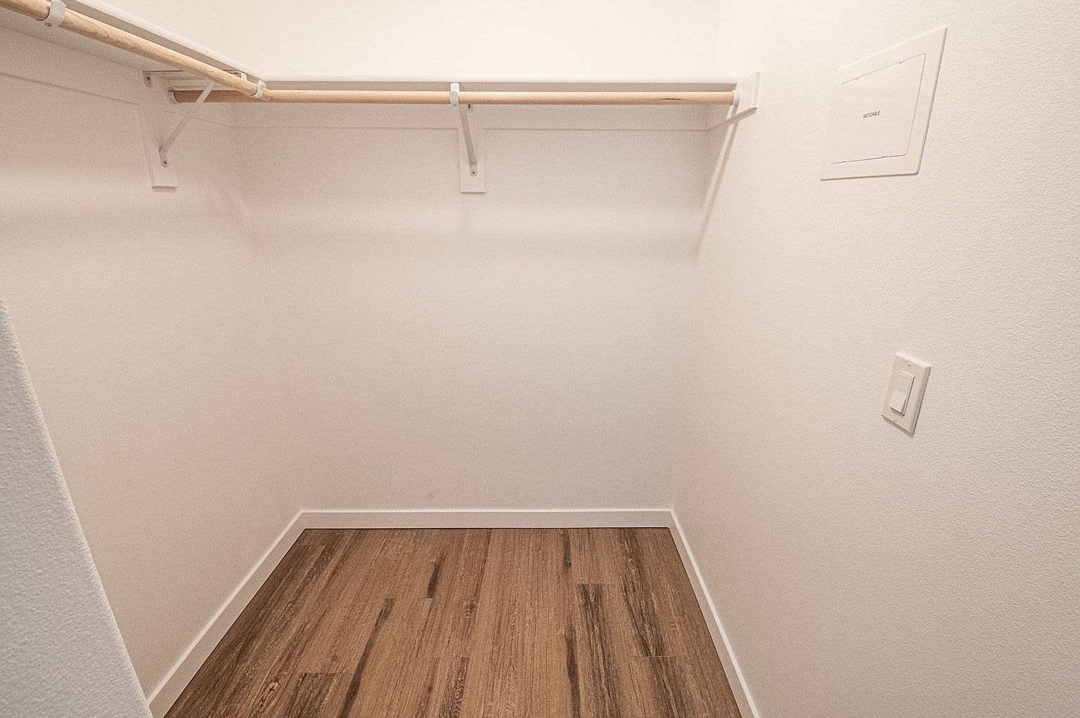 Luxurious walk-in closet adorned with wooden floors at Pine View in La Pine, Oregon