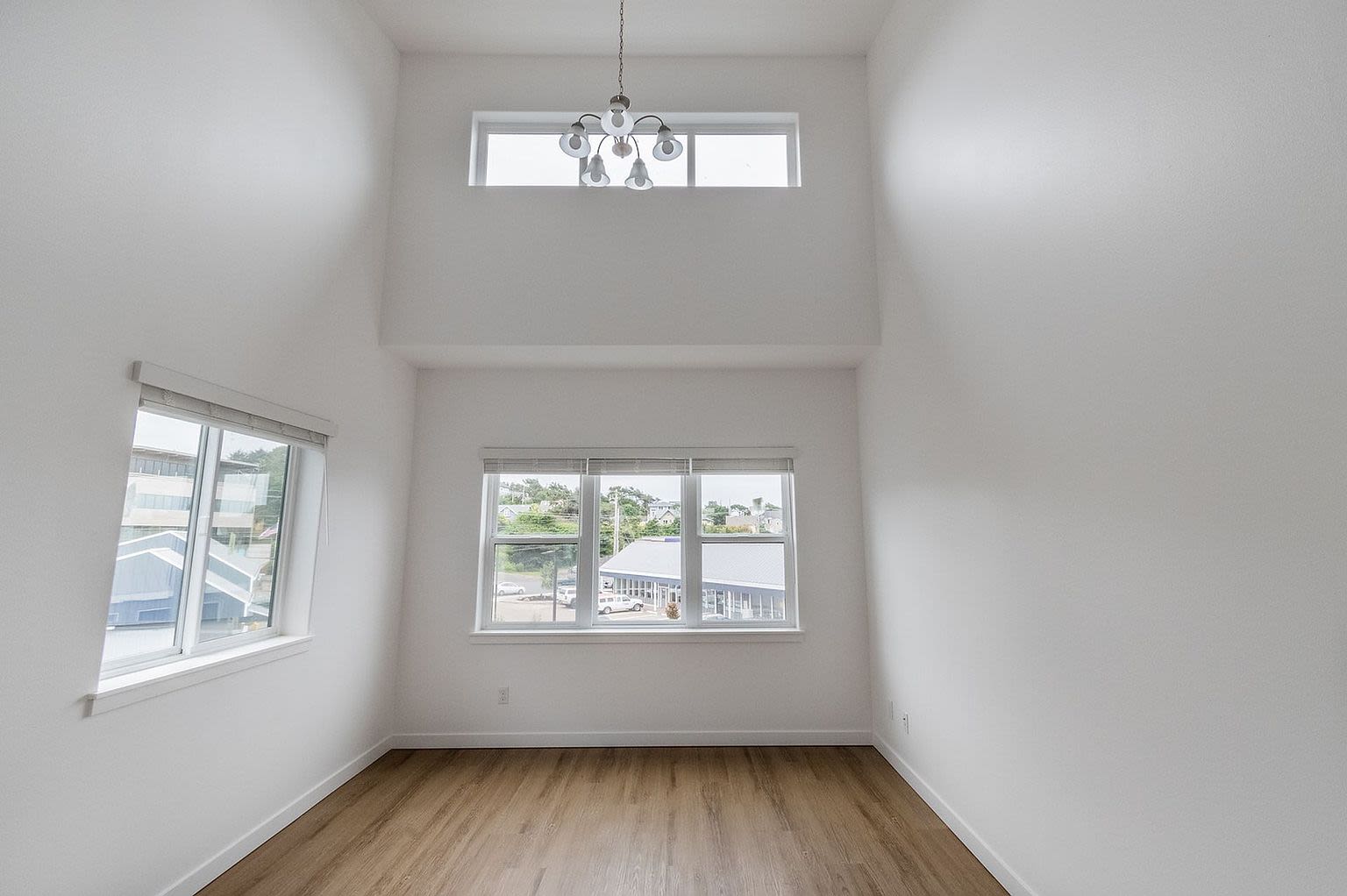 A bright room with a window and smooth hardwood floors at Pine View in La Pine, Oregon
