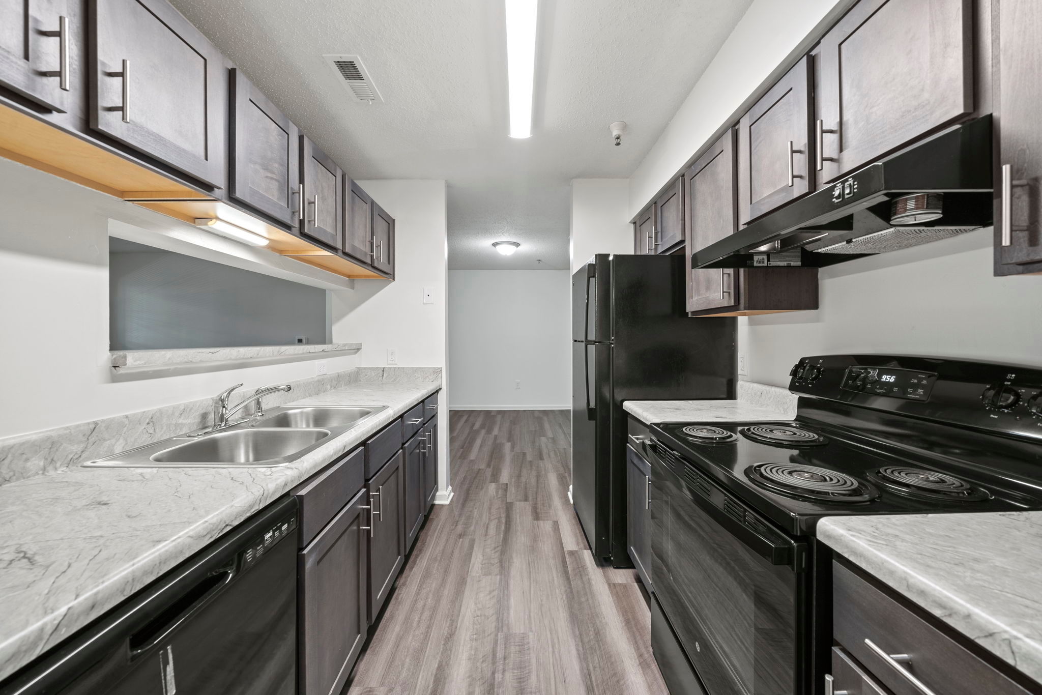 Fully-equipped kitchen with wood-style flooring at Salem Run in Fredericksburg, Virginia