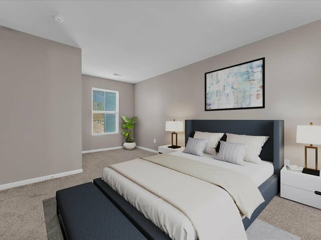 A beautiful bed in a bedroom with carpet flooring at Wyndham Hill in Grand Rapids, Michigan