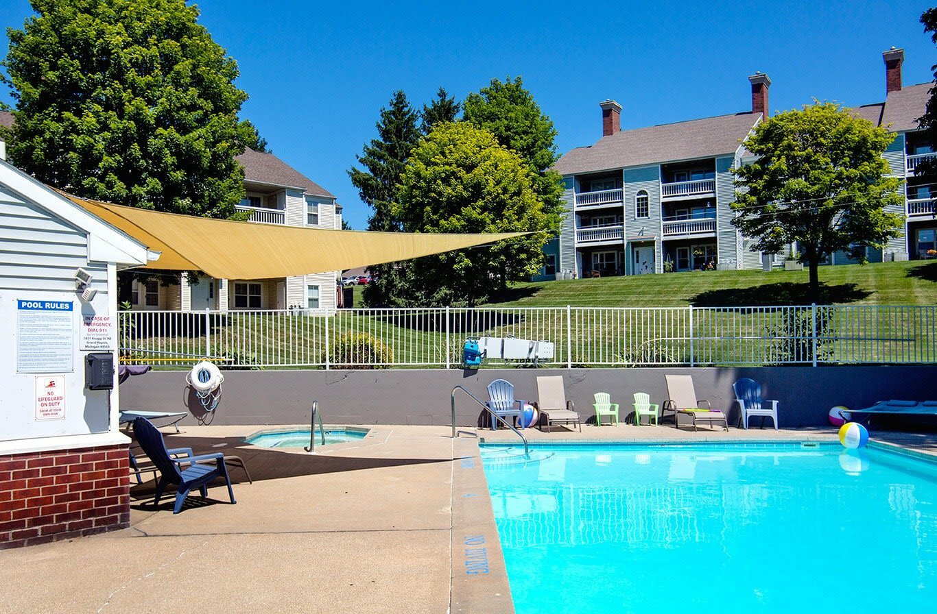 View of the apartment buildings and a swimming pool at Wyndham Hill in Grand Rapids, Michigan