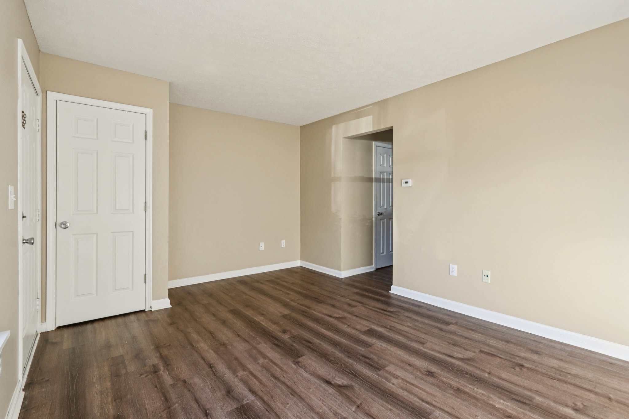 Unfurnished living room with access to other rooms of the apartments at Fox Pointe Apartments in Columbus, Indiana