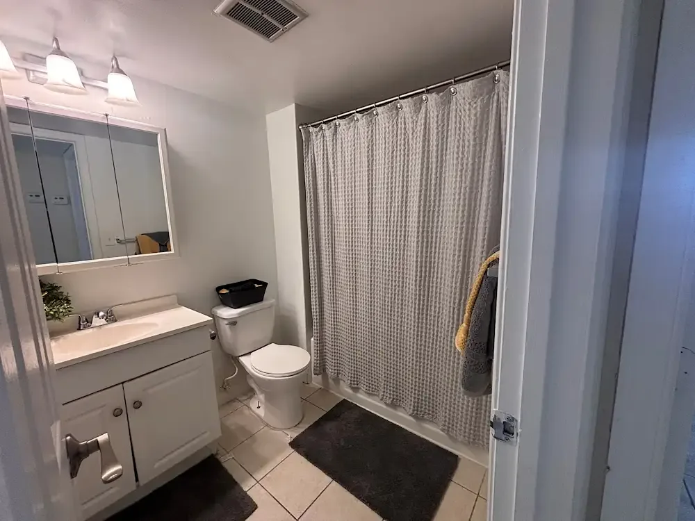 Bathroom with bath-sink and a tub at Banyan Club East in Pompano Beach, Florida
