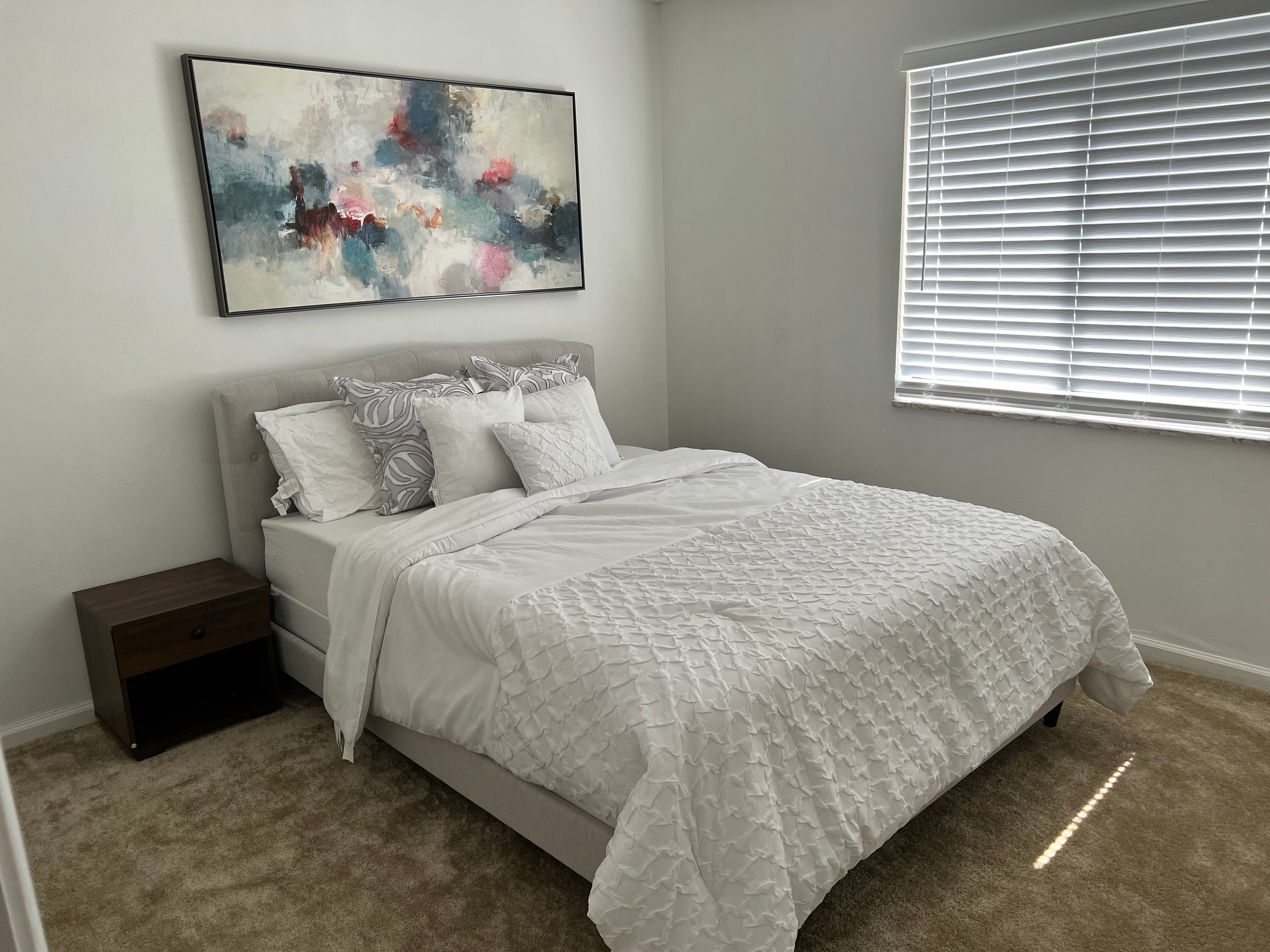 Bedroom with a bed and a window at Banyan Club East in Pompano Beach, Florida