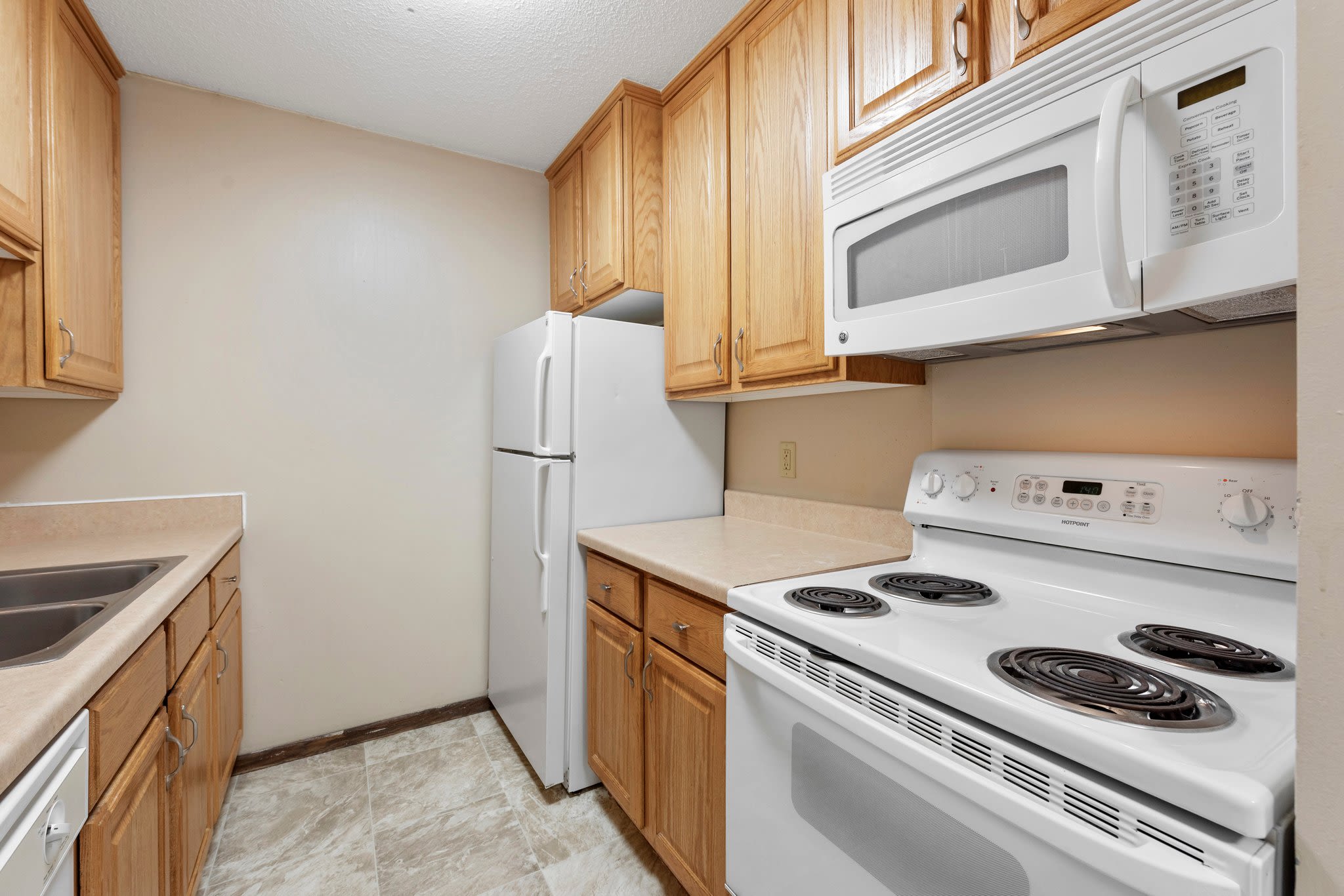 Kitchen room showing white colored appliances at Shamrock Court Apartments in Saint Paul, Minnesota