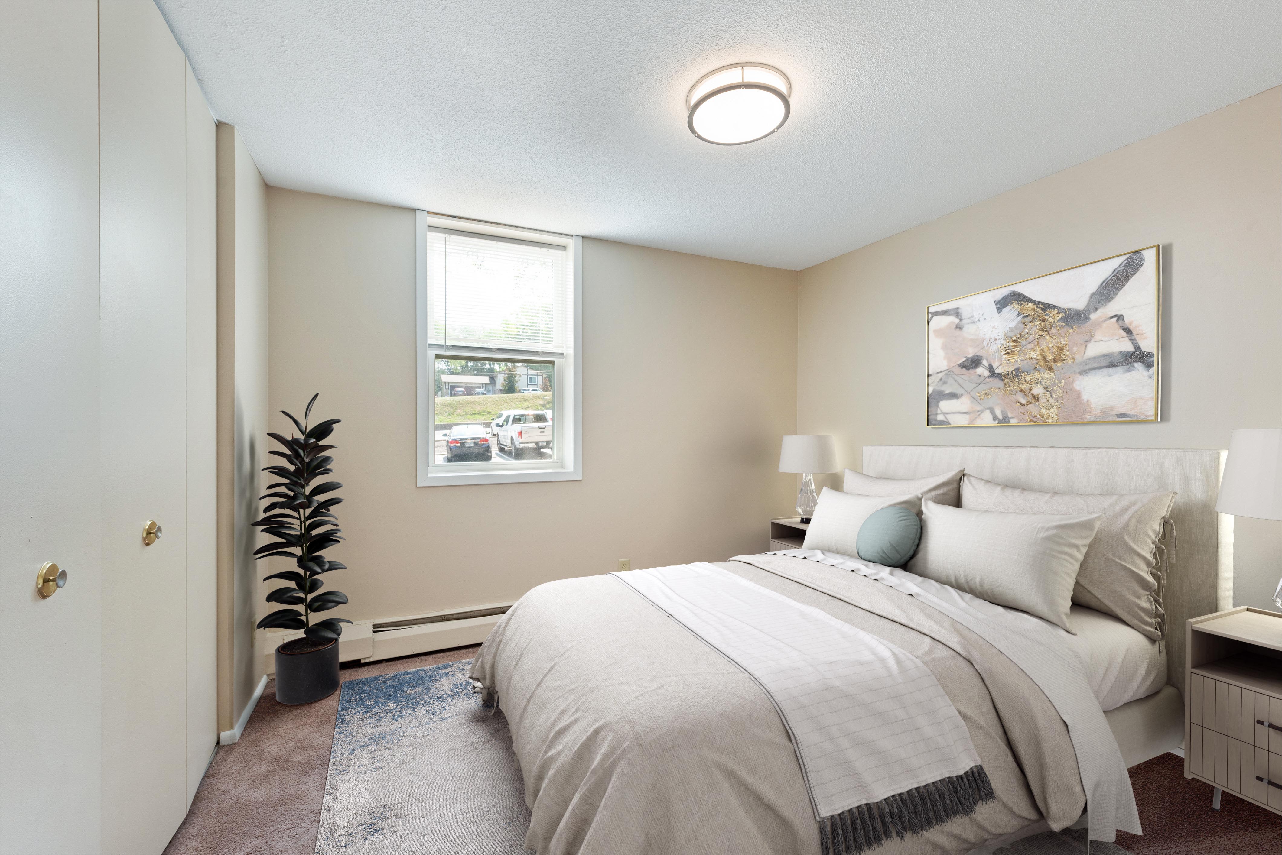 A view of a bedroom showing a comfy bed at Shamrock Court Apartments in Saint Paul, Minnesota