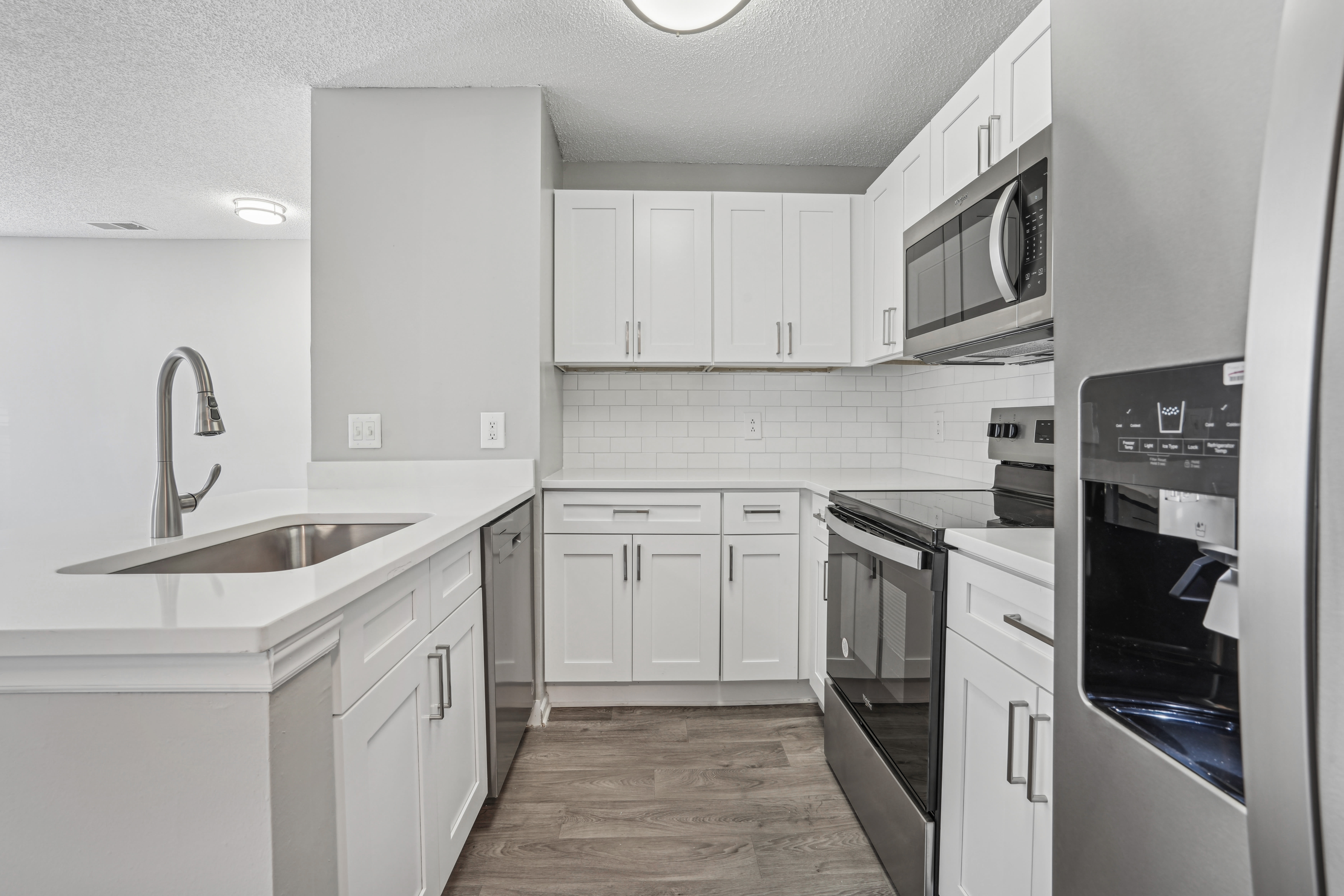 Modern kitchen with refrigerator at Niner Woods in Charlotte, North Carolina