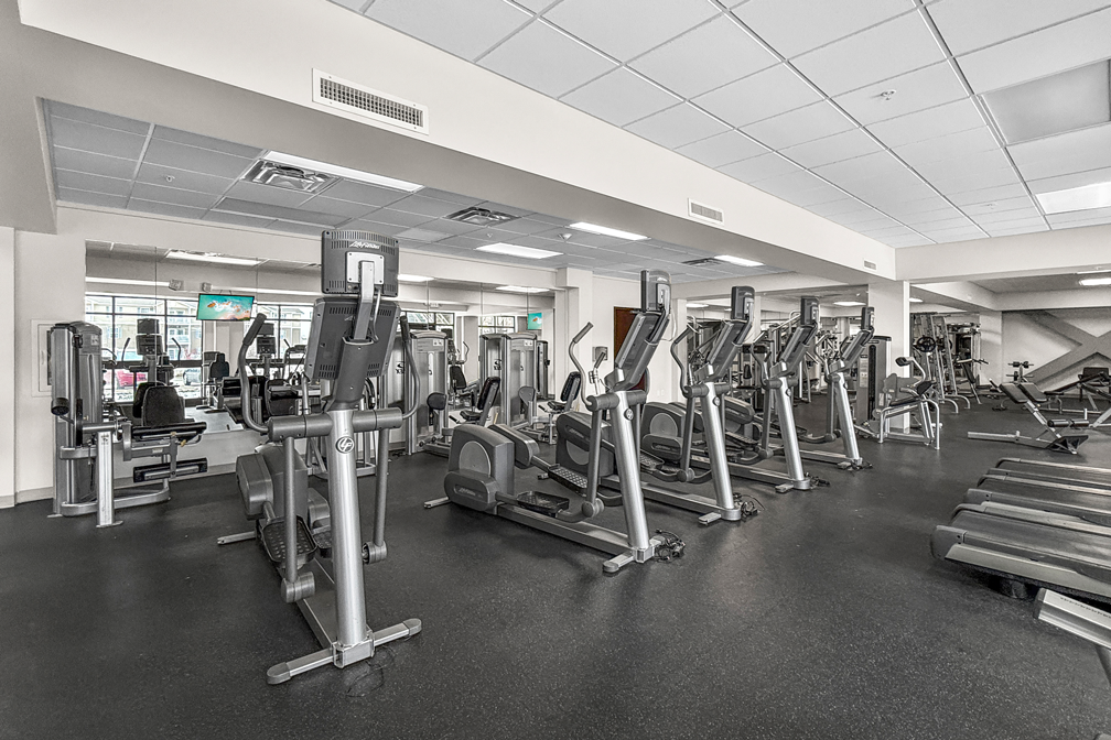 Spacious fitness center with rows of treadmills and exercise equipment at The Franklin in Ankeny, Iowa