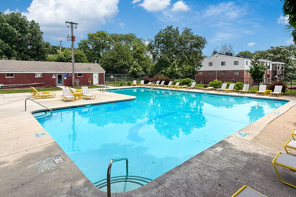 Outdoor swimming pool with lounge chairs at Wakonda Village in Des Moines, Iowa