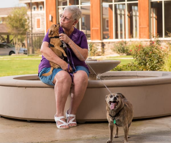 一位妇女带着她的狗在综合亚虎娱乐集团管理的社区里, 位于Southlake, 德州