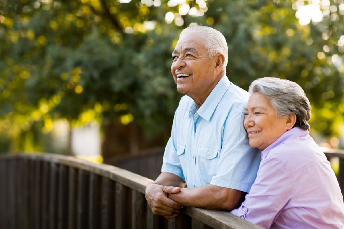 Resident couple walking over a bridge in a park near Crystal Terrace of Klamath Falls in Klamath Falls, Oregon