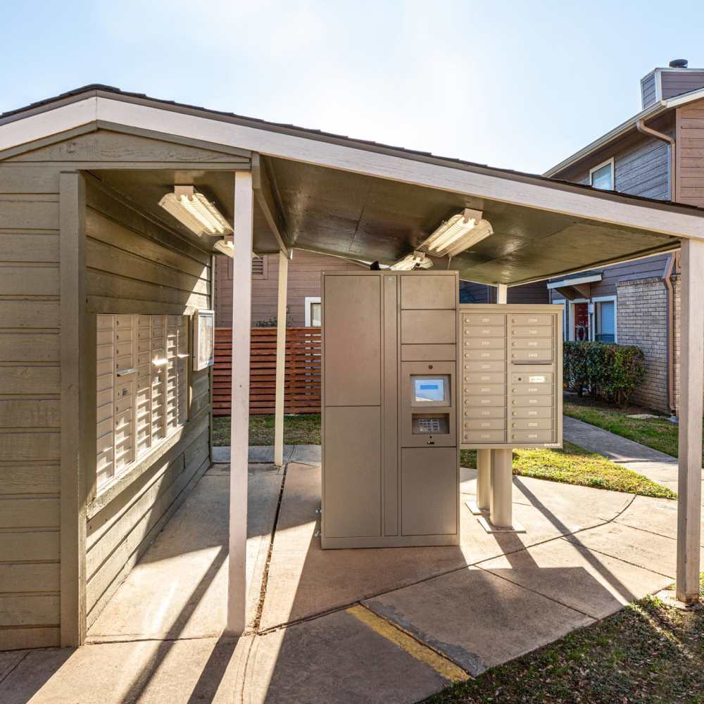 Metal package lockers under a roof at The Camaron Townhomes & Flats in San Antonio, Texas