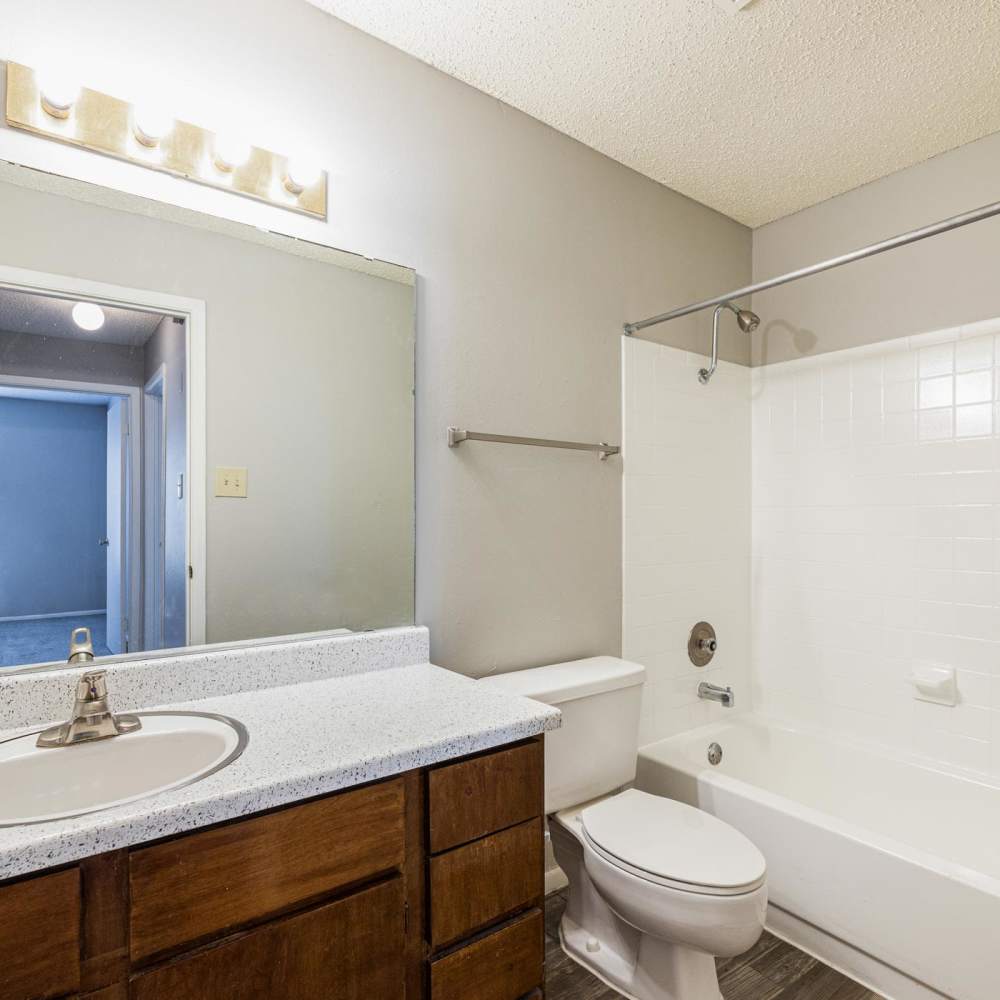 Bathroom sink with mirror and light fixture at The Camaron Townhomes & Flats in San Antonio, Texas