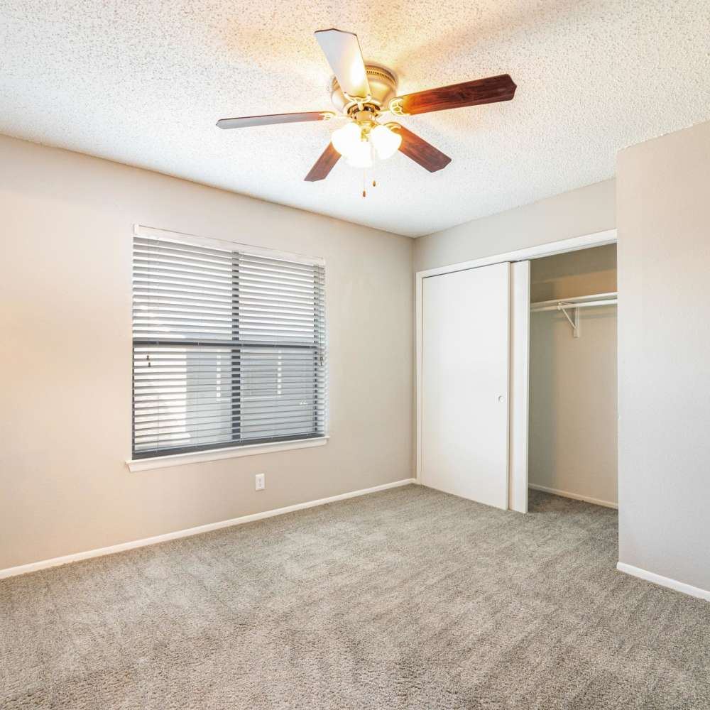 Window with blinds and ceiling fan at The Camaron Townhomes & Flats in San Antonio, Texas