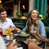 Resident friends out for a feast at their favorite restaurant near The Camaron Townhomes & Flats in San Antonio, Texas