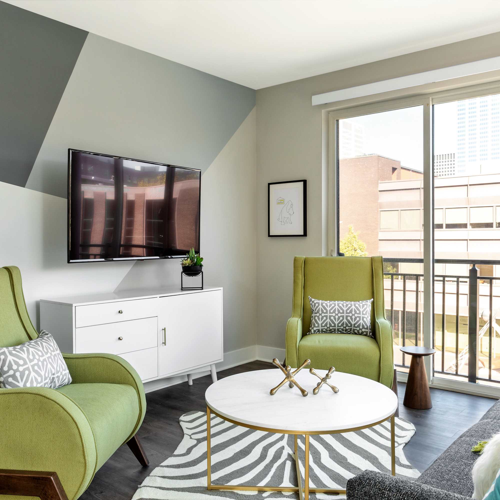 Green chairs and a round coffee table at 223 E Town in Columbus, Ohio