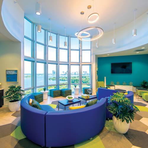 Bright lounge area with large windows at Bayview Student Living in North Miami, Florida