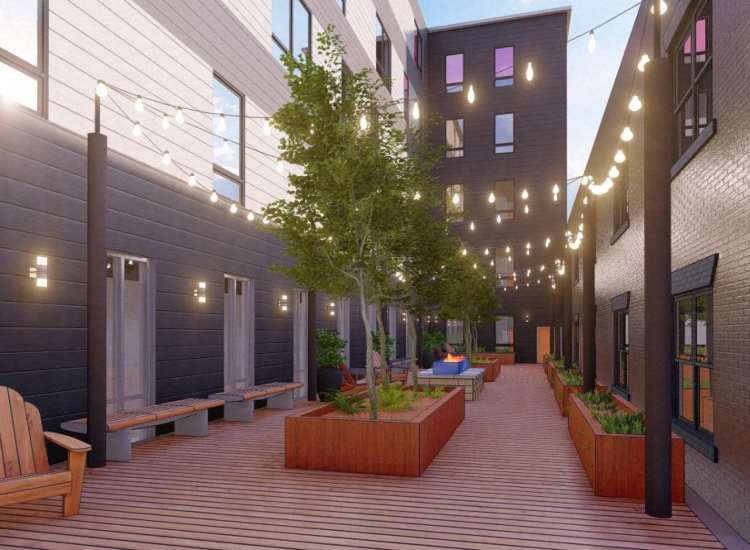 Outdoor seating area with string lights at Fourth at Broadway in Chelsea, Massachusetts