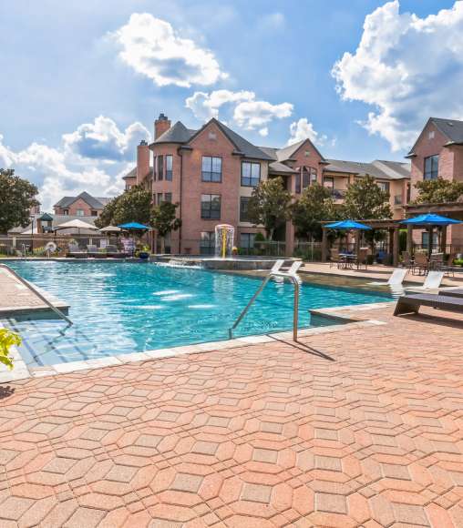 Resort-style pool surrounded by lounge chairs at Vintage Park in Houston, Texas