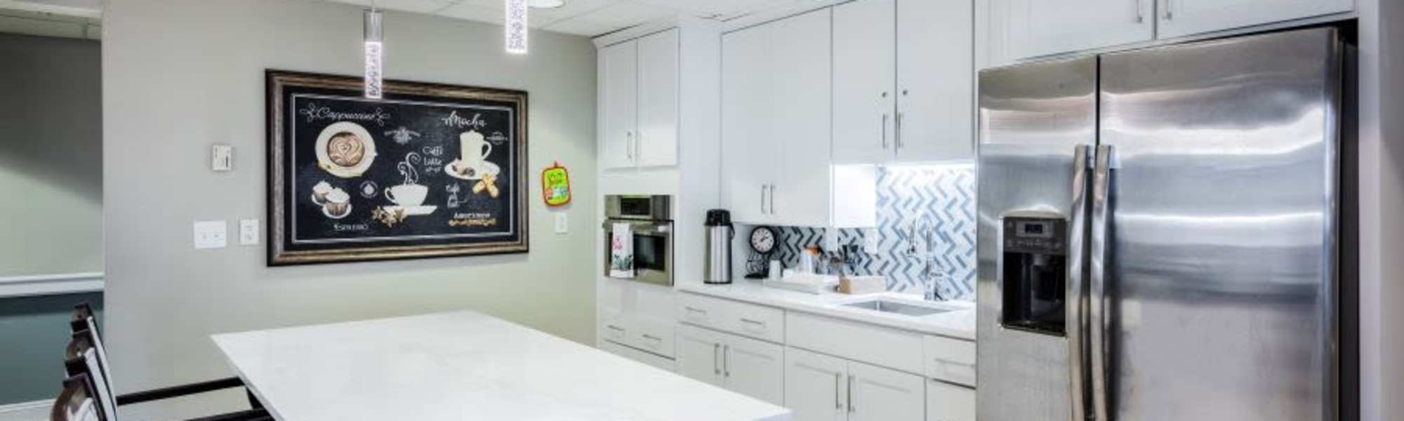 White cabinets and stainless steel appliances at Barclay House of Oakleaf Village in Lexington, South Carolina