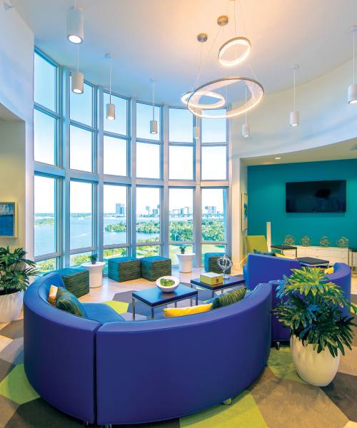 Bright, open lounge with large windows at Bayview Student Living in North Miami, Florida