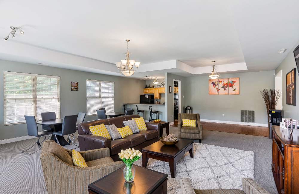 Chairs surround a dining table with windows at Indian Footprints Apartments in Harrison, Ohio