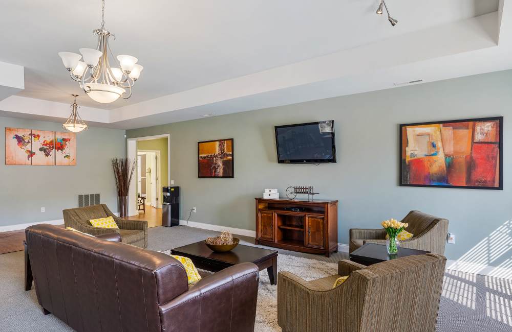 Brown leather sofa with decorative pillows at Indian Footprints Apartments in Harrison, Ohio