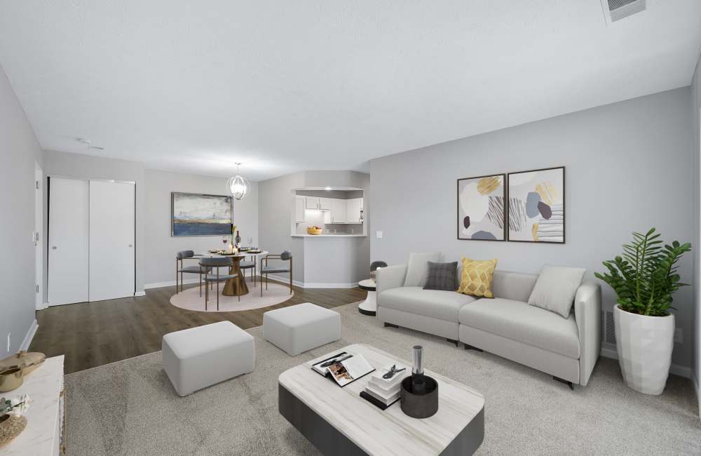 Living room with sofa, coffee table, and dining area at Indian Footprints Apartments in Harrison, Ohio