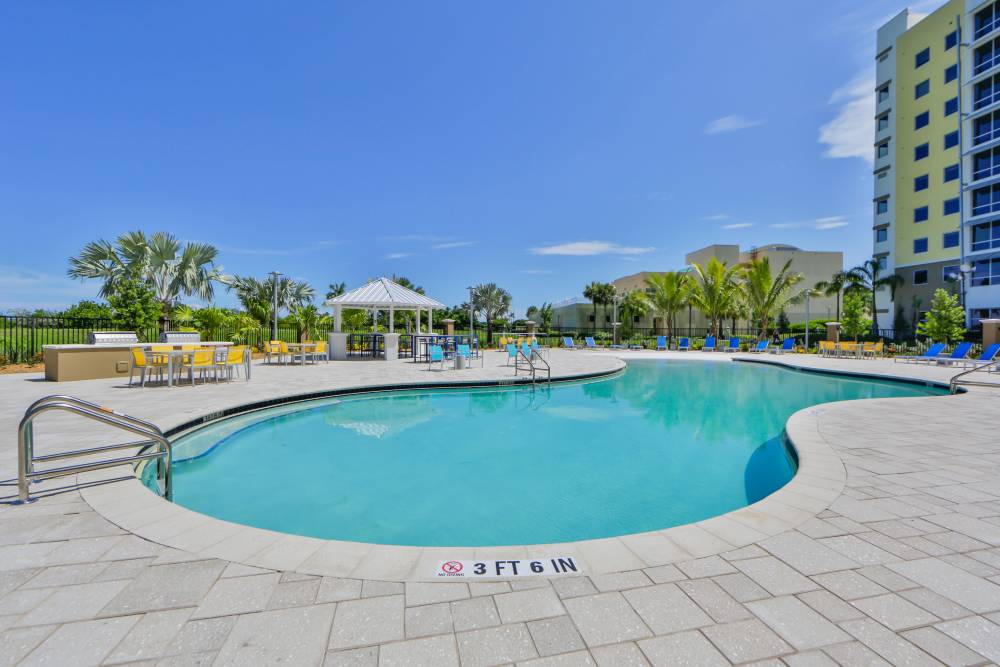 Sparkling pool with lounge chairs at Bayview Student Living in North Miami, Florida