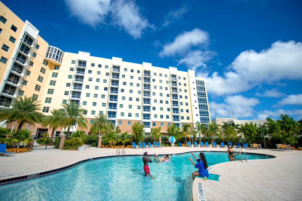 Sparkling pool with children playing at Bayview Student Living in North Miami, Florida