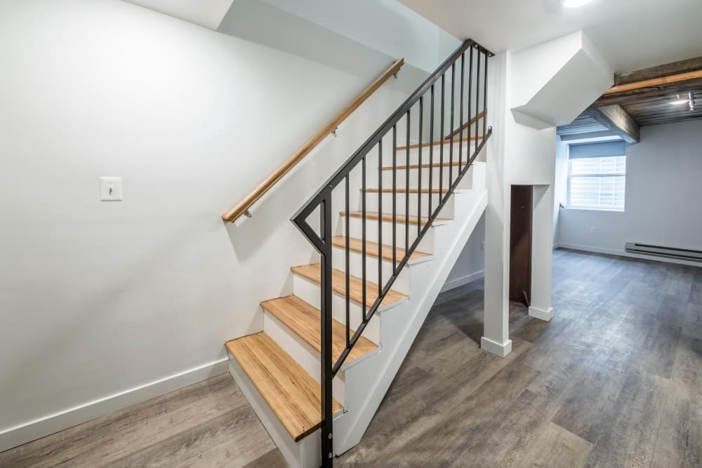 Staircase with wooden steps and metal railing at Brush Factory Lofts in Philadelphia, Pennsylvania