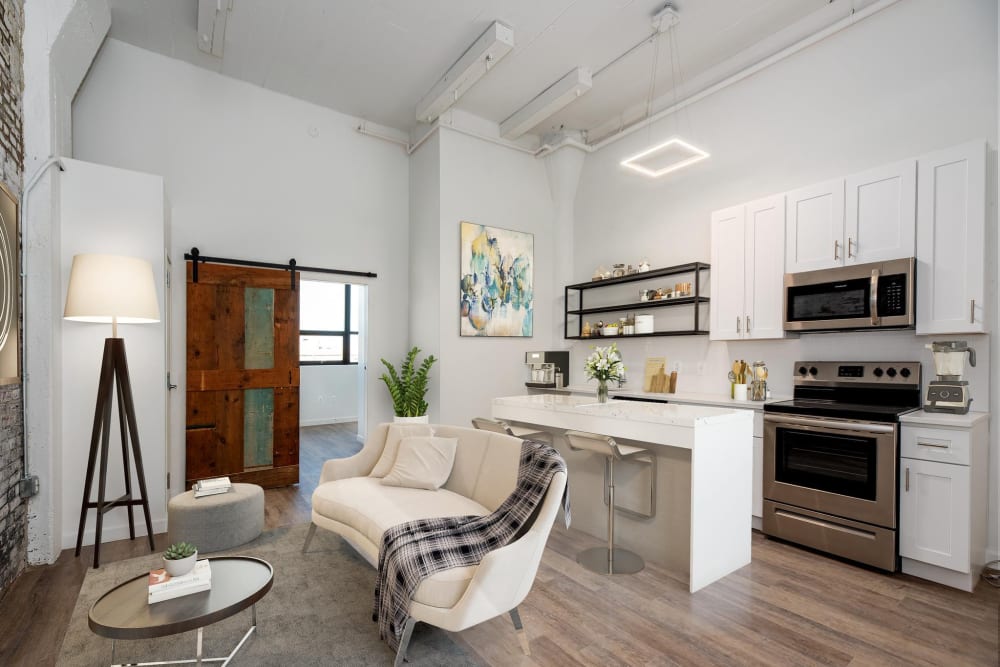 White kitchen cabinets and stainless steel appliances at Brush Factory Lofts in Philadelphia, Pennsylvania
