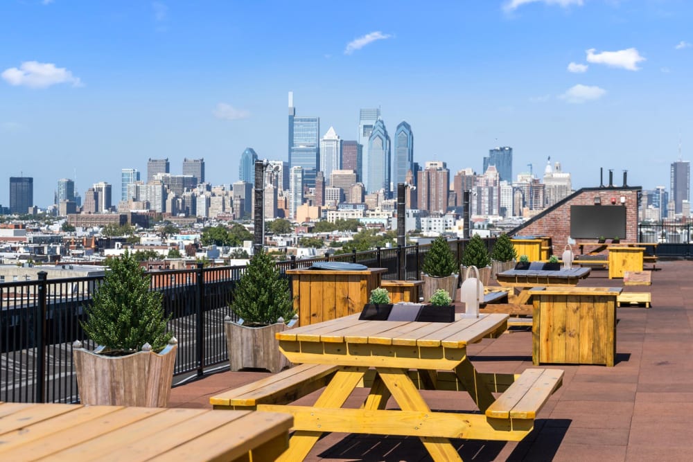 Wooden picnic tables with planters at Brush Factory Lofts in Philadelphia, Pennsylvania