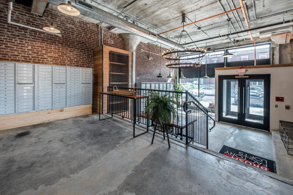 Mailboxes against a brick wall with a staircase at Brush Factory Lofts in Philadelphia, Pennsylvania