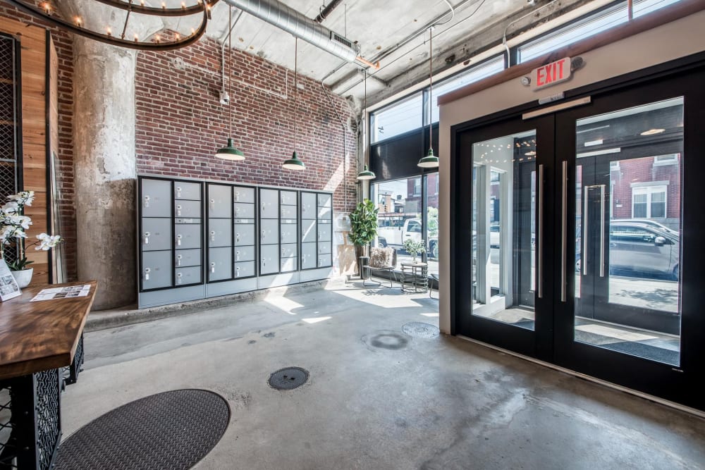 Gray lockers against a brick wall at Brush Factory Lofts in Philadelphia, Pennsylvania