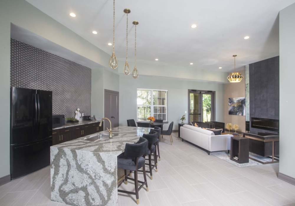 Modern open-concept kitchen and living area with a marble island at Lakeside Villas in Baton Rouge, Louisiana