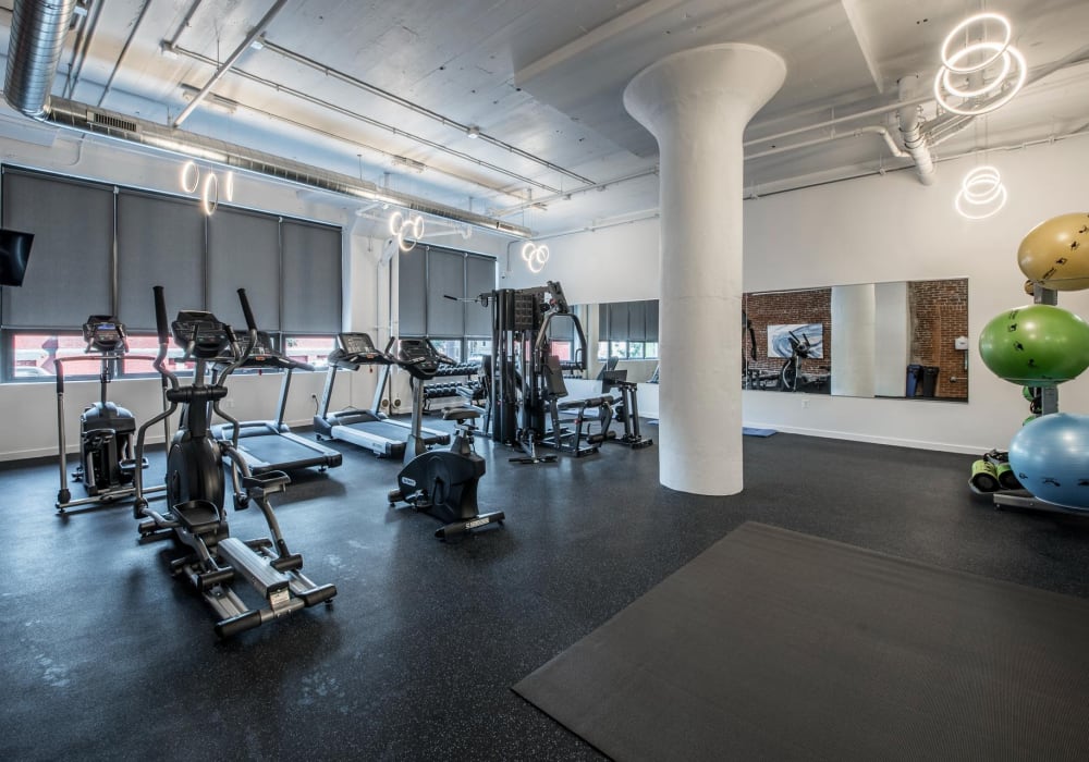 Fitness equipment with mirrors and exercise mats at Brush Factory Lofts in Philadelphia, Pennsylvania