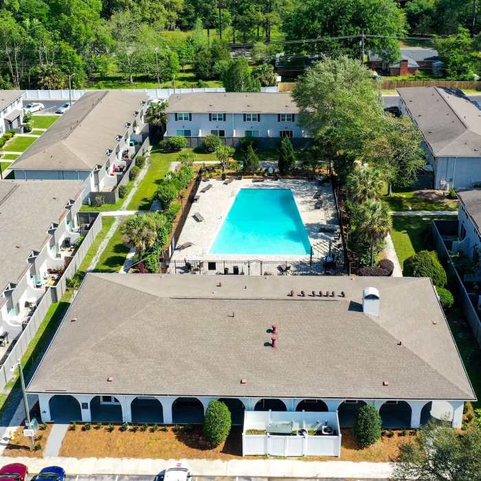 Resort-style pool surrounded by landscaped grounds at Crescent Place in Savannah, Georgia