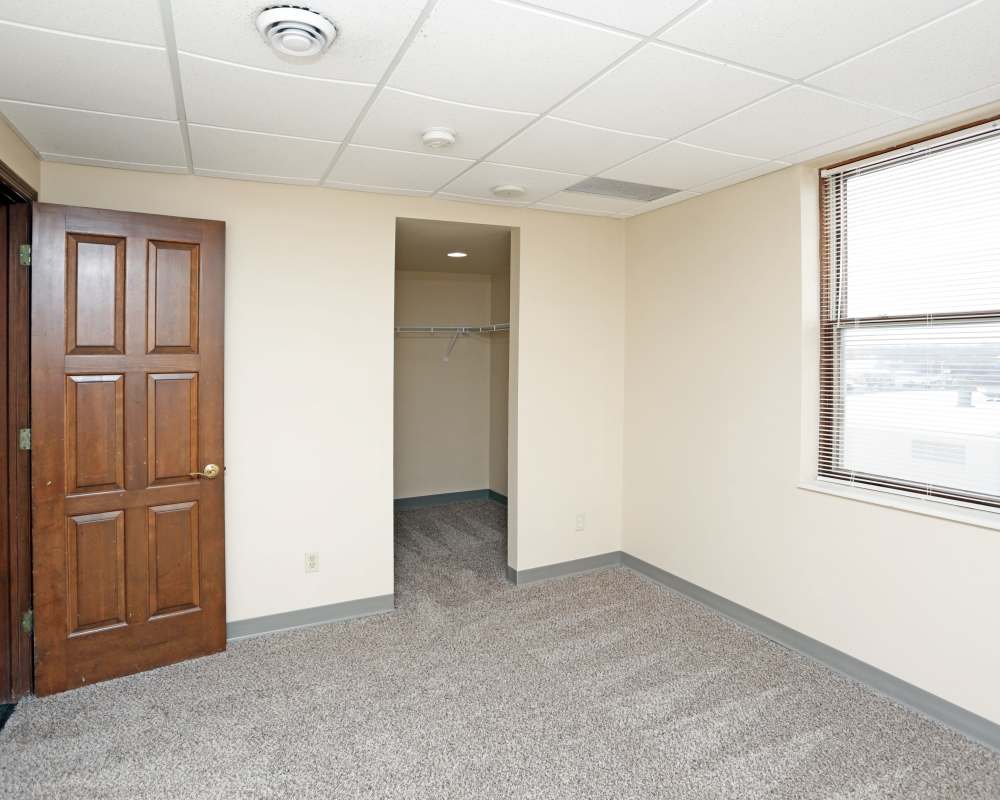Bedroom with carpeted flooring and closet at The Roosevelt in Cedar Rapids, Iowa