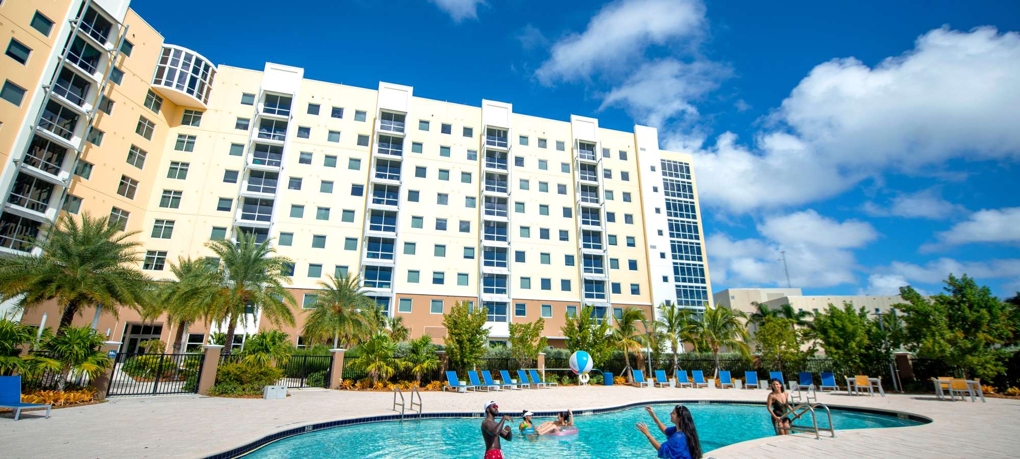 Resort-style pool with families enjoying at Bayview Student Living in North Miami, Florida 