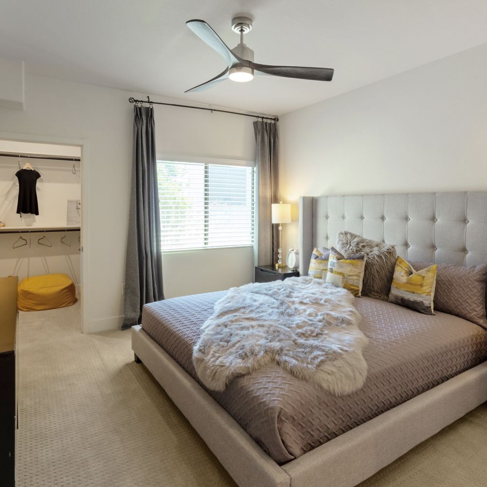 Cozy bedroom with plush bedding and natural light at Revolution in Henderson, Nevada