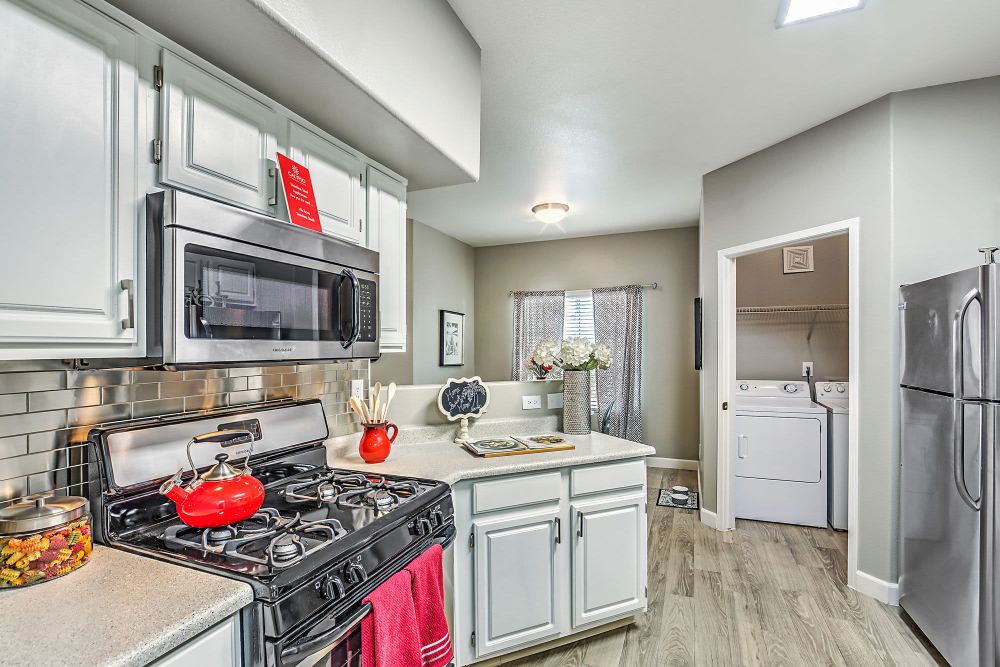 Kitchen with wood-style flooring at Calypso Apartments in Las Vegas, Nevada