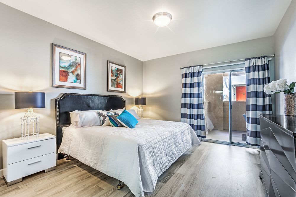 Bedroom with access to the patio or balcony at Calypso Apartments in Las Vegas, Nevada