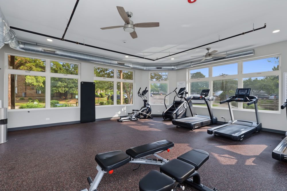 Bright fitness center with cardio machines at Arrowhead in Palatine, Illinois