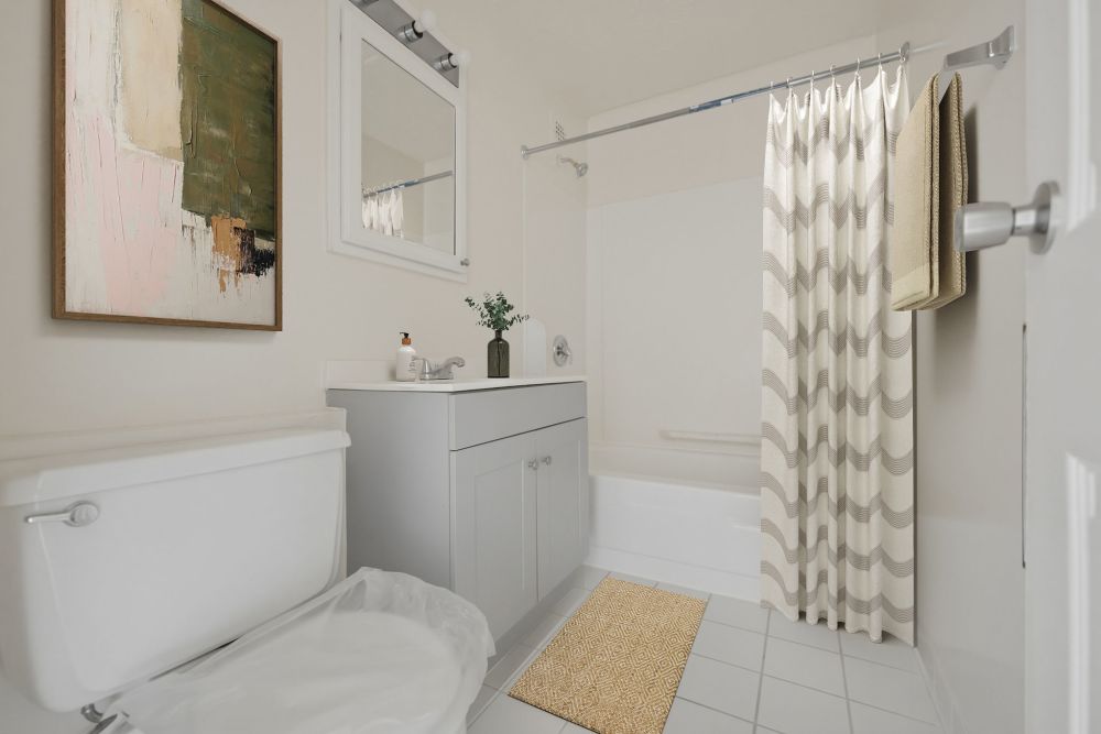 Modern bathroom with tub and stylish decor at Patchogue Village at Terry, an Eagle Rock Community in Patchogue, New York