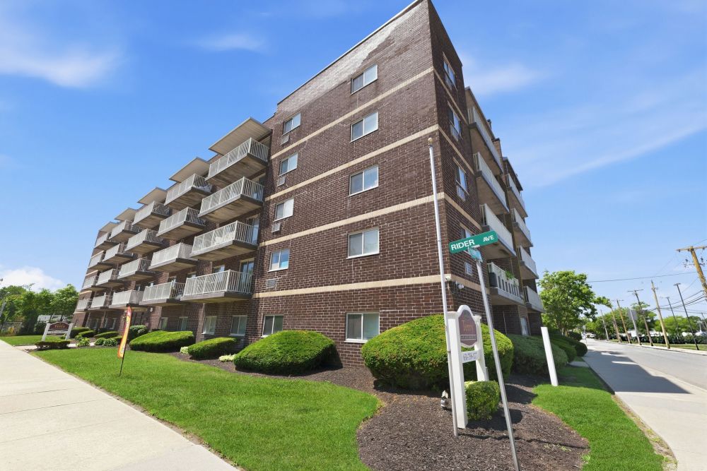 Building exterior with balconies at Patchogue Village at Terry, an Eagle Rock Community in Patchogue, New York