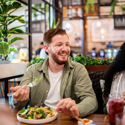 Man enjoying meal in bright, modern restaurant near Arrowhead in Palatine, Illinois