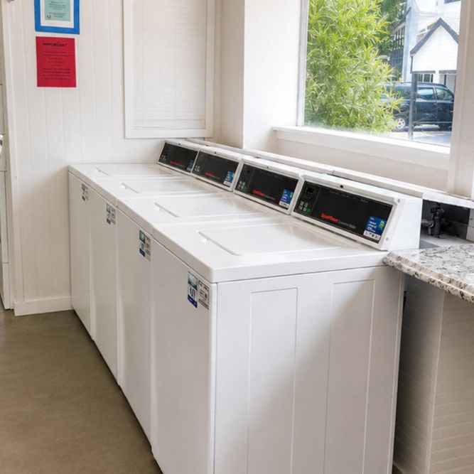 Laundry machines in bright, clean laundry room at Serenity at Cityside in Houston, Texas