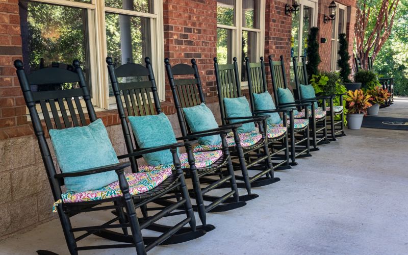 Covered porch with rocking chair seating at Barclay House of Rock Hill in Rock Hill, South Carolina